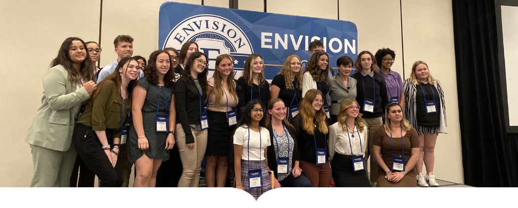 Students huddle for a group picture