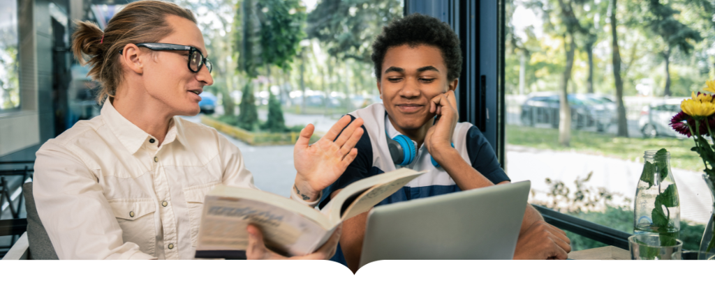 Mentor and student in a cafe studying and smiling