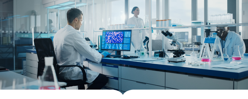 Scientist sitting at a computer in a lab